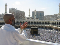 A pilgrim at the Masjid al-Haram in Mecca.  The Kaaba is seen in the midground.